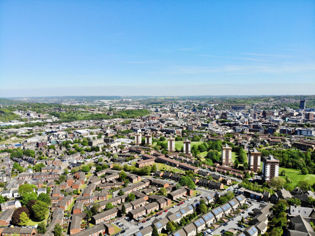 An aerial view of an urban area showing trees and parks